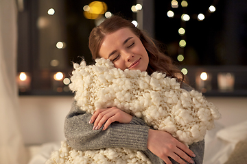 Image showing happy young woman with soft pillow in bed at home