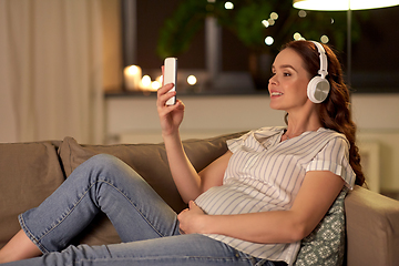 Image showing pregnant woman with smartphone and headphones