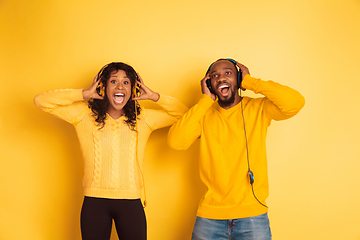 Image showing Young emotional african-american man and woman on yellow background