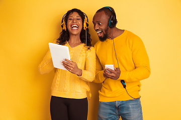 Image showing Young emotional african-american man and woman on yellow background