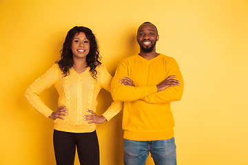 Image showing Young emotional african-american man and woman on yellow background