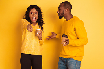 Image showing Young emotional african-american man and woman on yellow background