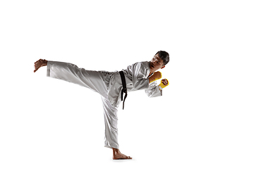 Image showing Confident korean man in kimono practicing hand-to-hand combat, martial arts