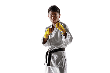 Image showing Confident korean man in kimono practicing hand-to-hand combat, martial arts