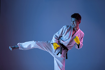 Image showing Confident korean man in kimono practicing hand-to-hand combat, martial arts