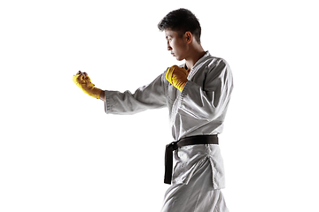 Image showing Confident korean man in kimono practicing hand-to-hand combat, martial arts