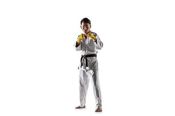 Image showing Confident korean man in kimono practicing hand-to-hand combat, martial arts