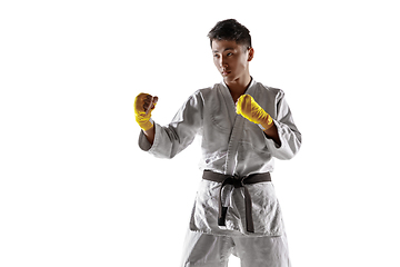 Image showing Confident korean man in kimono practicing hand-to-hand combat, martial arts