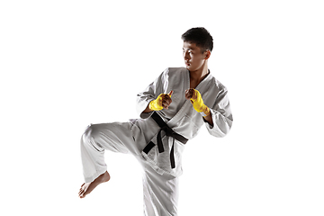 Image showing Confident korean man in kimono practicing hand-to-hand combat, martial arts