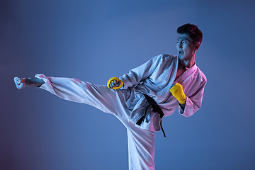 Image showing Confident korean man in kimono practicing hand-to-hand combat, martial arts