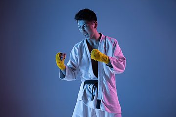 Image showing Confident korean man in kimono practicing hand-to-hand combat, martial arts