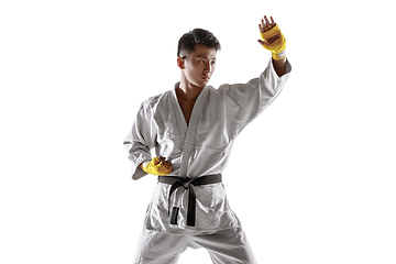 Image showing Confident korean man in kimono practicing hand-to-hand combat, martial arts