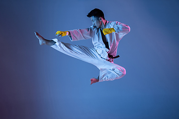 Image showing Confident korean man in kimono practicing hand-to-hand combat, martial arts