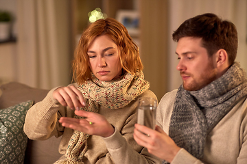 Image showing sick couple taking medicine at home