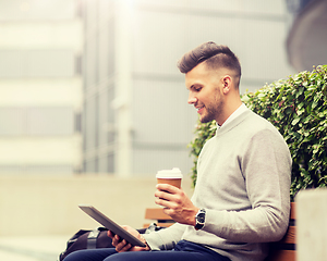 Image showing man with tablet pc and coffee on city street bench