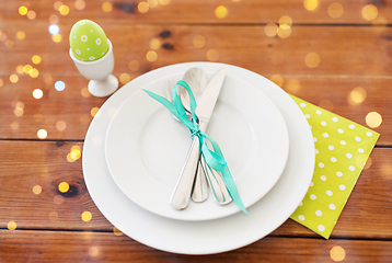 Image showing easter egg in cup holder, plates and cutlery