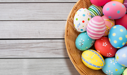 Image showing close up of colored easter eggs in wicker basket