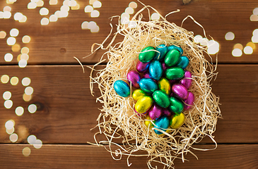 Image showing chocolate eggs in foil wrappers in straw nest