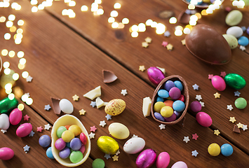 Image showing chocolate eggs and candy drops on wooden table