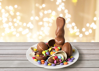 Image showing chocolate bunny, eggs and candies over lights