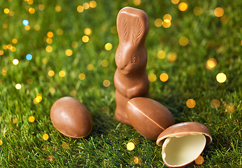 Image showing chocolate bunny and easter eggs on grass