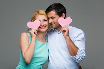 Image showing Beautiful couple holding pink hearts