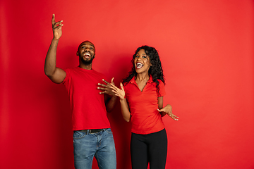 Image showing Young emotional african-american man and woman on red background