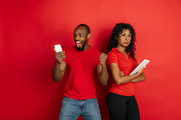 Image showing Young emotional african-american man and woman on red background