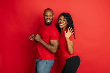 Image showing Young emotional african-american man and woman on red background