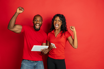 Image showing Young emotional african-american man and woman on red background