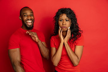 Image showing Young emotional african-american man and woman on red background