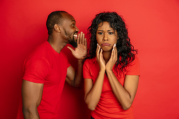 Image showing Young emotional african-american man and woman on red background