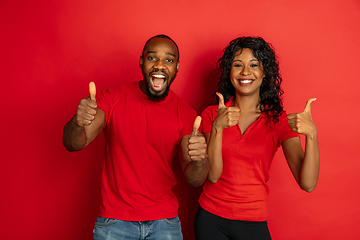 Image showing Young emotional african-american man and woman on red background