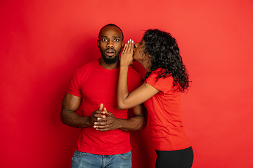 Image showing Young emotional african-american man and woman on red background