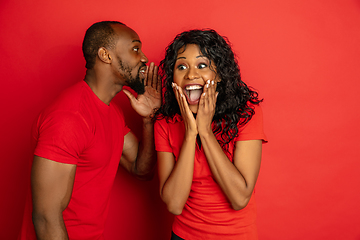 Image showing Young emotional african-american man and woman on red background