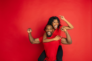 Image showing Young emotional african-american man and woman on red background