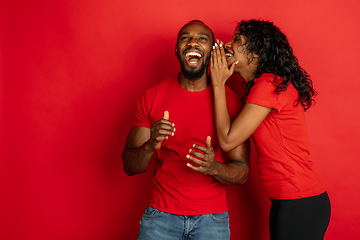 Image showing Young emotional african-american man and woman on red background