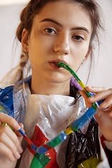 Image showing Woman addicted of sales and clothes, wearing plastic, recycling concept