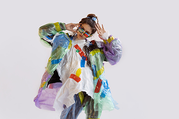 Image showing Woman addicted of sales and clothes, wearing plastic, recycling concept