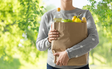 Image showing close up of woman with paper bag full of food