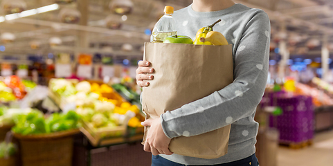 Image showing close up of woman with paper bag full of food