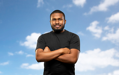 Image showing african american man with crossed arms over sky