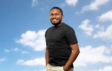 Image showing smiling african american man over blue sky