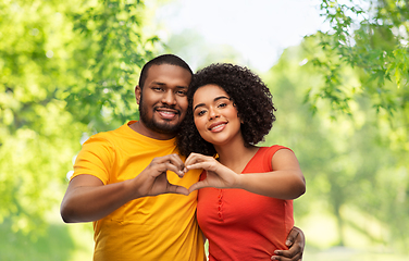 Image showing happy african american couple making hand heart