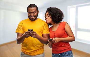 Image showing happy african american couple with smartphones