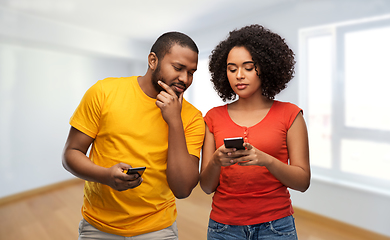 Image showing happy african american couple with smartphones