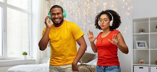 Image showing african american couple with headphones dancing