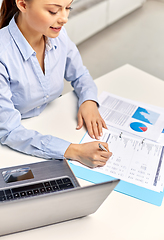 Image showing businesswoman with papers working at office