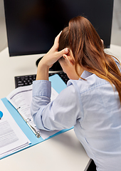 Image showing stressed businesswoman with papers at office