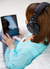 Image showing woman with tablet pc and headphones at home